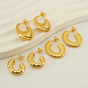 Detailed view of three pairs of textured 18K gold-plated U-shaped and fan-shaped earrings