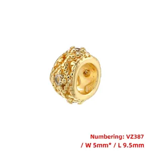 Detailed close-up of a 5x9.5mm hollow gold-plated charm bead with clear cubic zirconia