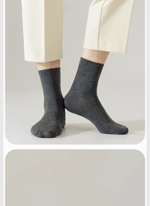 Detail of grey cotton mid-calf socks for men featuring premium knitted texture on foot