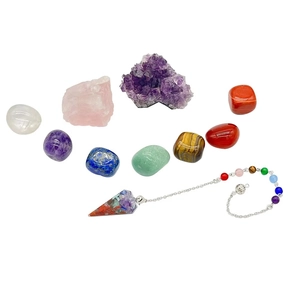 Natural healing crystal chakra stone set with amethyst cluster and polished stones on white