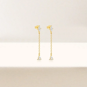 Detailed close-up of S925 hallmark on gold tassel earrings with diamond accents