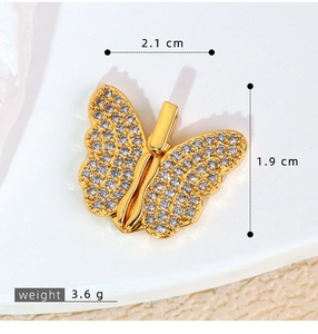 Macro detail of gold butterfly pendant with cubic zirconia, dimensions 2.1cm by 1.9cm