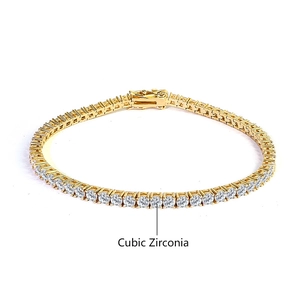 Detailed close-up of golden tennis bracelet featuring shimmering cubic zirconia stones