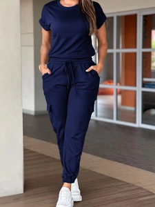 Detail of dark blue short sleeve jumpsuit with drawstring waist and cargo style cuffs