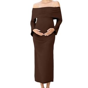 Close-up of brown off-shoulder maternity dress with elastic knitted fabric and long sleeves