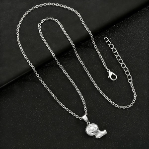 Detailed close-up of football and soccer cleat pendants on a black leather texture