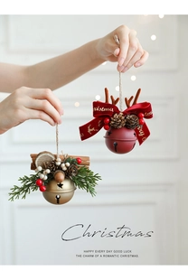 Close-up of red and gold Christmas bells with pine cones, antlers and berries on ropes