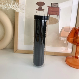Detail of 20pcs black high-elastic hair ties in a clear storage jar for hair styling