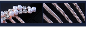 Detailed macro view of rhinestone and pearl inlay on a rose gold metal hair comb accessory