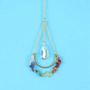 Detail of golden moon suncatcher with chakra stones and pear-shaped crystal prism