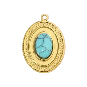 Macro shot of an oval turquoise stone pendant with a vintage gold embossed sunburst frame