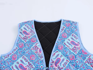 Close-up of quilted cotton vest with blue paisley pattern and black diamond lining