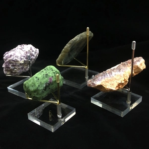 Macro shot of colorful mineral specimens on transparent acrylic and metal display stands