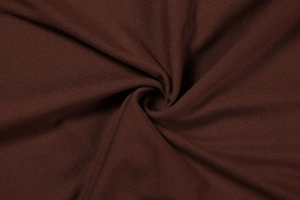 Macro detail of deep brown knit fabric showing smooth matte texture and soft drape