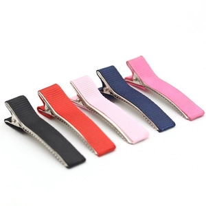 Detail of candy-colored striped ribbon duckbill hair clips in various bright shades