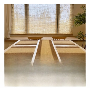 Close-up of woven jute placemats and table runner set in striped coffee and beige colors