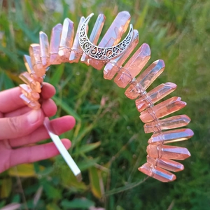 Detailed shot of hollow metal moon and orange crystals on a delicate tiara headband