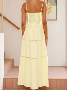 Detail of yellow backless dress with elastic smocking and tiered cake skirt layers