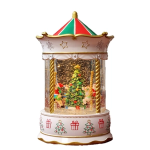 Christmas carousel music box with LED lights, swirling snow, and Santa on a white base