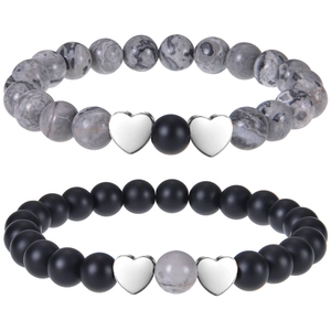 Detailed macro view of beaded couple bracelets with tiger eye stones and heart charms