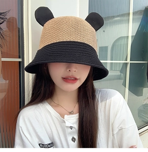 Detail of knit bucket hat with cute bear ears in beige and black contrast design