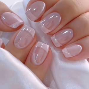 Classic French tip press-on nails in nude pink with a short square oval shape