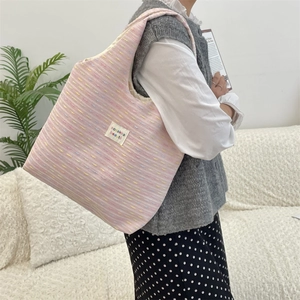 Detail of pink striped canvas tote bag showing texture and sozakka beauté woven label
