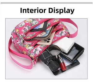 Detail of large floral nylon crossbody bag showing multiple zippered pockets and interior storage