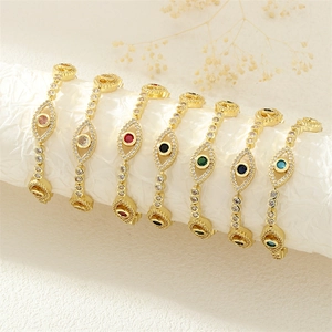 Evil eye bracelets in gold plating with colored zircon stones on a white stand