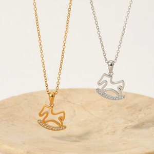 Rocking horse pendant necklace in gold and silver with sparkling cubic zirconia stones