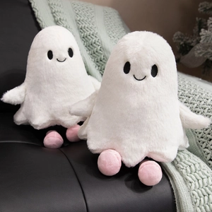 Close-up of two white plush ghosts with pink feet on a soft sofa for Halloween gift
