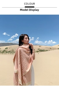 Close-up of pink houndstooth cashmere shawl with fringe details in desert landscape