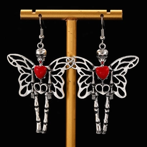 Detailed view of Gothic earrings featuring skull butterfly wings and red heart charms
