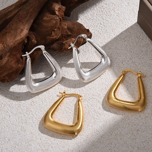 Minimalist brushed metal triangle hoop earrings in gold and silver finish with matte texture