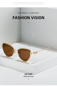 Cat eye sunglasses detail with golden frame, heart-shaped temples and brown lenses