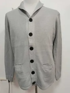 Detail of grey men's knit cardigan featuring a shawl collar and large black buttons