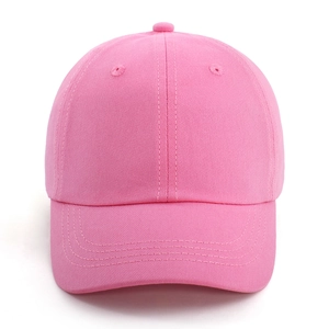 Detailed view of pink cotton baseball cap with six-panel structure and curved brim