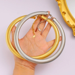 Punk style 18K gold and silver textured choker necklace shown in flexible hand-held view