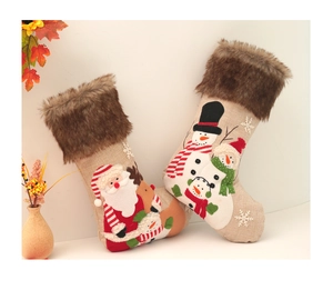 Detail of Christmas burlap stockings with plush reindeer and snowman embroidery