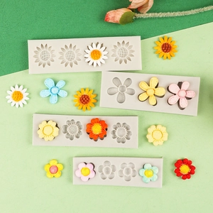 Detailed view of silicone flower molds with colorful fondant floral decorations