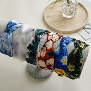 Crossed art print headbands featuring Van Gogh and Monet oil painting designs