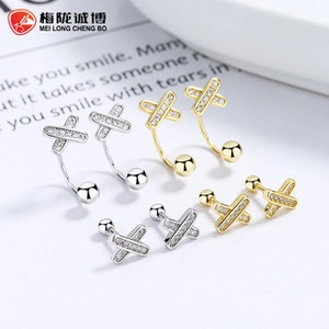 Detailed view of 925 sterling silver X-shaped cross earrings with micro-pave stones