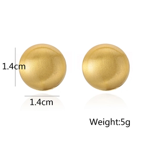 Detailed macro view of 1.4cm round gold ball earrings showing brushed metal texture and size