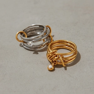 Close-up of interconnected stacked rings with cubic zirconia and mixed metal plating