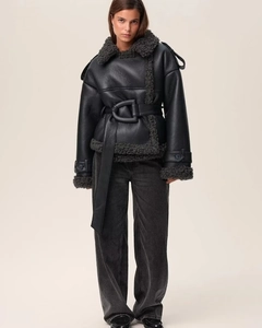 Detail of faux leather shearling jacket showing the wide waist belt and silver D-ring buckle