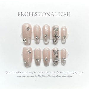 Handmade pink cat-eye press-on nails with silver glitter, butterfly, and rhinestones