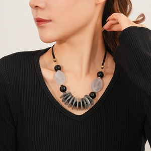 Detail of leather double-layer necklace featuring grey beads and golden accents