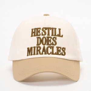 Adjustable two-tone baseball cap with 'HE STILL DOES MIRACLES' embroidery detail