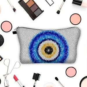 Portable Evil Eye print makeup bag with zipper closure and surrounding beauty tools