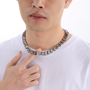 Close-up of 13mm silver titanium steel Cuban chain necklace worn by a male model